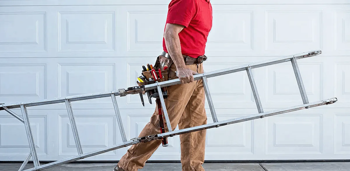 Garage door repair technician arriving with tools and ladder in Denver, CO